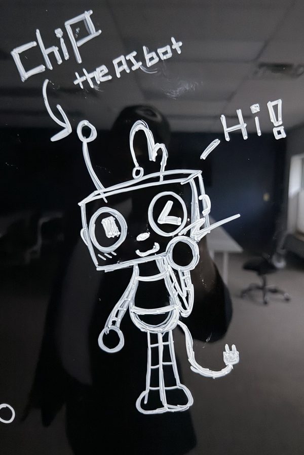 Chip as first drawn on the classroom whiteboard, with the words Chip the AI bot and Hi!