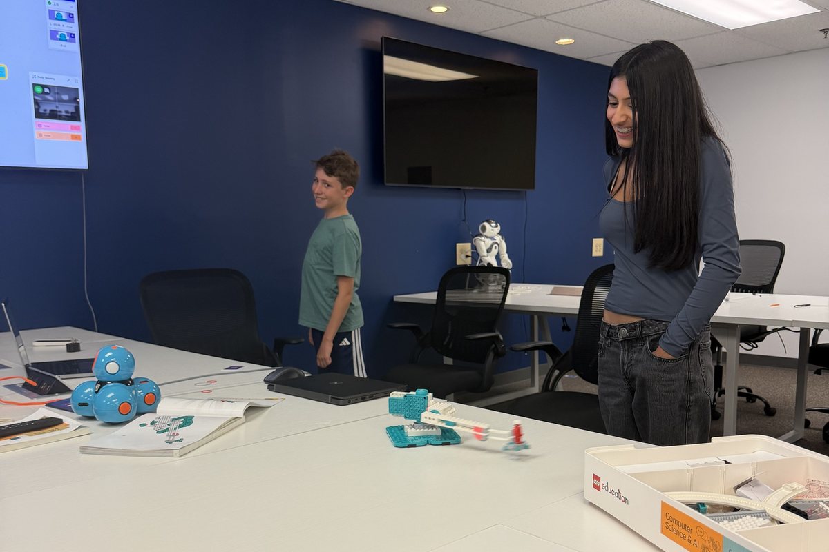 Two students at the Bridgewater center with Dash, LEGO and NAO robots